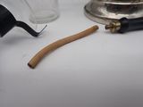 a glass jar with a wooden handle next to a metal object