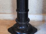 a black pedestal with a clock on top of it