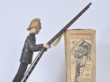 figurine of a man climbing a ladder with a stick