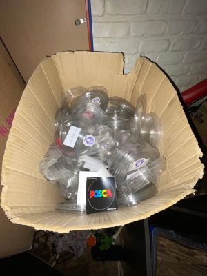 a cardboard box full of water bottles and a cell phone