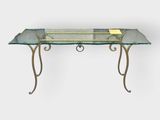 a glass table with metal legs and a glass top