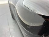 a reflection of a person in the side mirror of a car