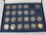 an image of a blue box containing a variety of silver coins