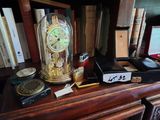 a clock that is sitting on top of a book shelf
