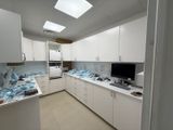 an image of a kitchen with a lot of clutter on the counter