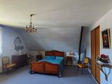 a bedroom with a bed and a chandelier in it