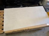 a pile of white tiles on a pallet in a warehouse