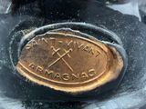 a close up of a metal object with a gold medal on it