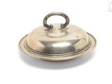 a silver plate with a lid on it on a white surface