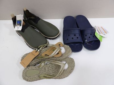 two pairs of sandals and a pair of flip flops on a table