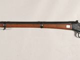 a rifle with a wooden barrel on a white background