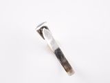 a close up of a silver tie bar on a white surface