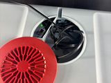 a red fan sitting on top of a white stove