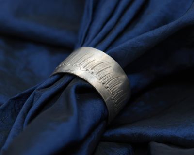a close up of a napkin with a ring on top of it