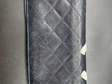leather wallet on a table with a white diamond on the front