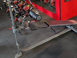 an image of a gym room with a row of exercise equipment