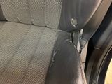 a close up of a seat in a car with a broken arm rest