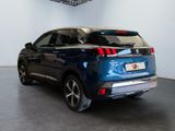 the rear end of a blue suv parked in a showroom