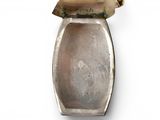 a silver spoon with a wooden handle on a white surface