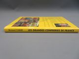 un livre jaune posé sur une table, à côté d'une table grise