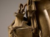 a statue of a woman holding a vase with a bird on it