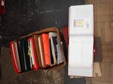 a box full of books sitting on a wooden floor