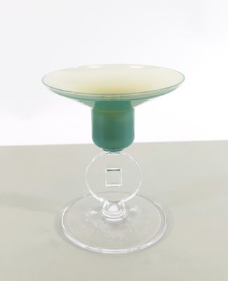 a glass cup that is sitting on top of a table