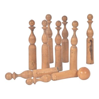 a group of wooden bottles and a bottle opener on a white background