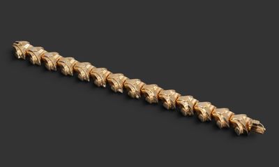gros plan d'un bracelet en or sur fond noir