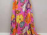 a pink and orange floral dress hanging on a hanger