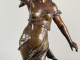 bronze statue of a woman with a flower in her hair