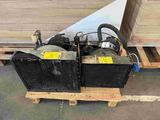 two air compressors sitting on a pallet in a warehouse