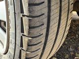 a tire on the ground next to a car