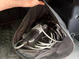 a person holding a bag with a bunch of wires inside of it