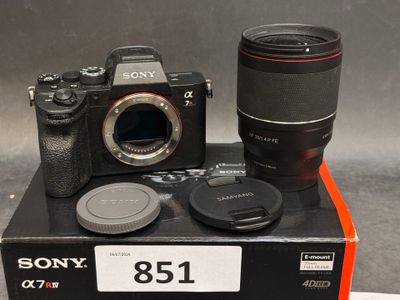 a camera and a lens sitting on top of a box