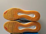 the soles of a pair of tennis shoes on top of a blue box