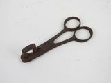 a pair of scissors on a table with a white background
