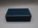 a small blue box sitting on top of a white table
