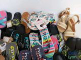 many pairs of sandals and sandals that are on the floor