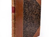 an old book with a brown leather cover on a white background