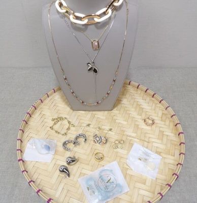 necklaces and bracelets are displayed on a display stand on a table