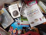 a pile of books and magazines in a box