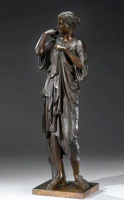 bronze statue of a woman holding a bird on a wooden base