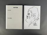 an open notebook with a drawing of a man ' s face on it