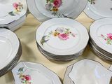 a lot of plates and bowls sitting on a table