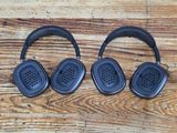 two black headphones sitting on a wooden table