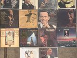 many different album covers on the wall of a room
