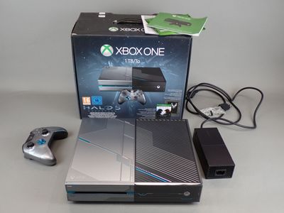 a box of xbox one and a game controller on a table