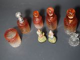 a lot of small glass bottles with figurines on them
