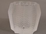 a glass vase that is sitting on a table